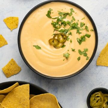 Vegan queso in a black bowl.