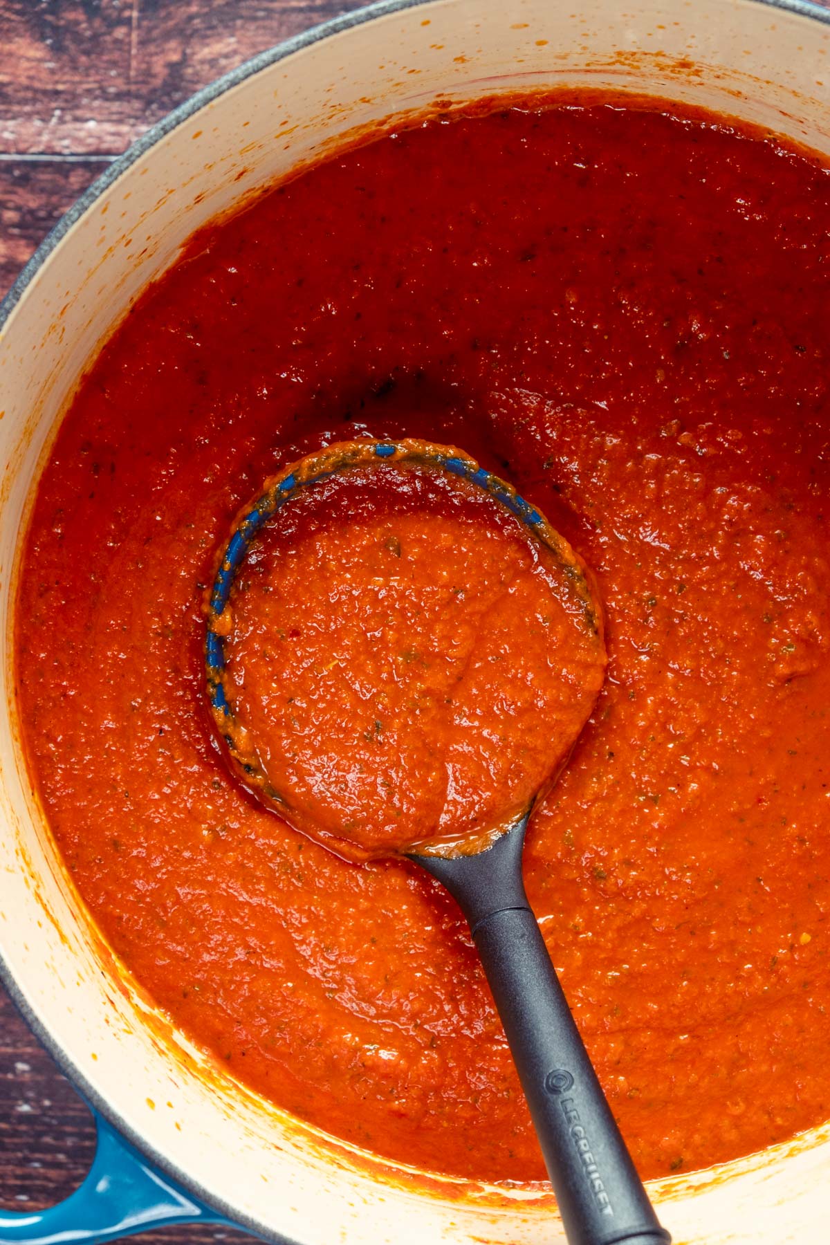 Vegan spaghetti sauce in a pot with a spoon.