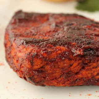 Vegan steak on a white plate.