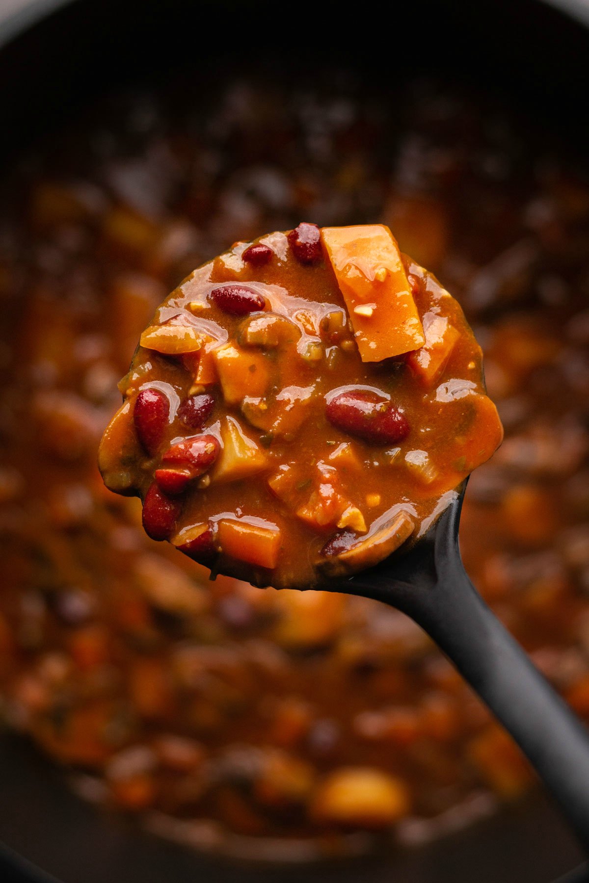 A serving spoon full of vegan stew. 