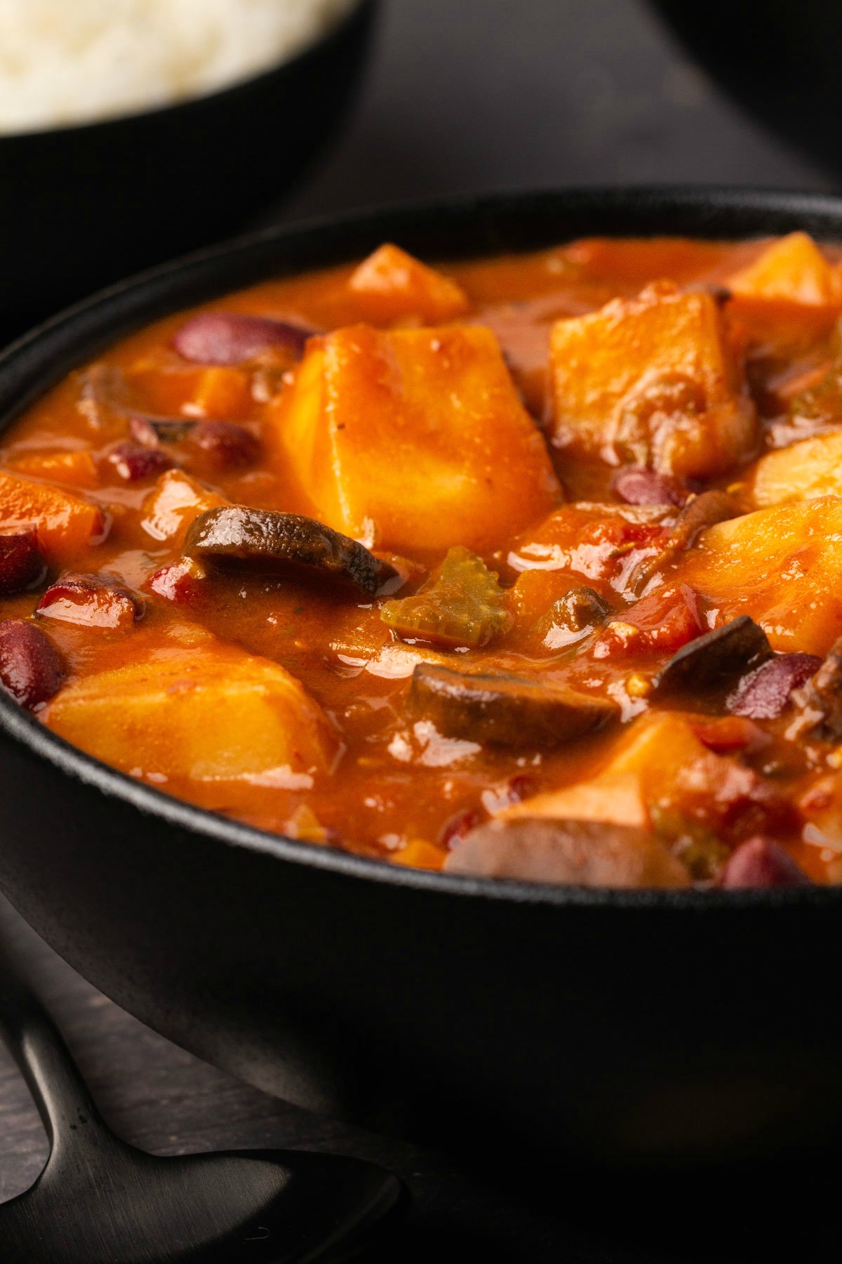 Vegan stew served in a black bowl. 