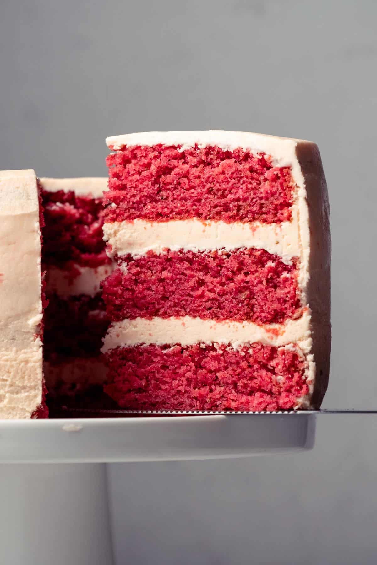 Slice of strawberry cake on a cake lifter.