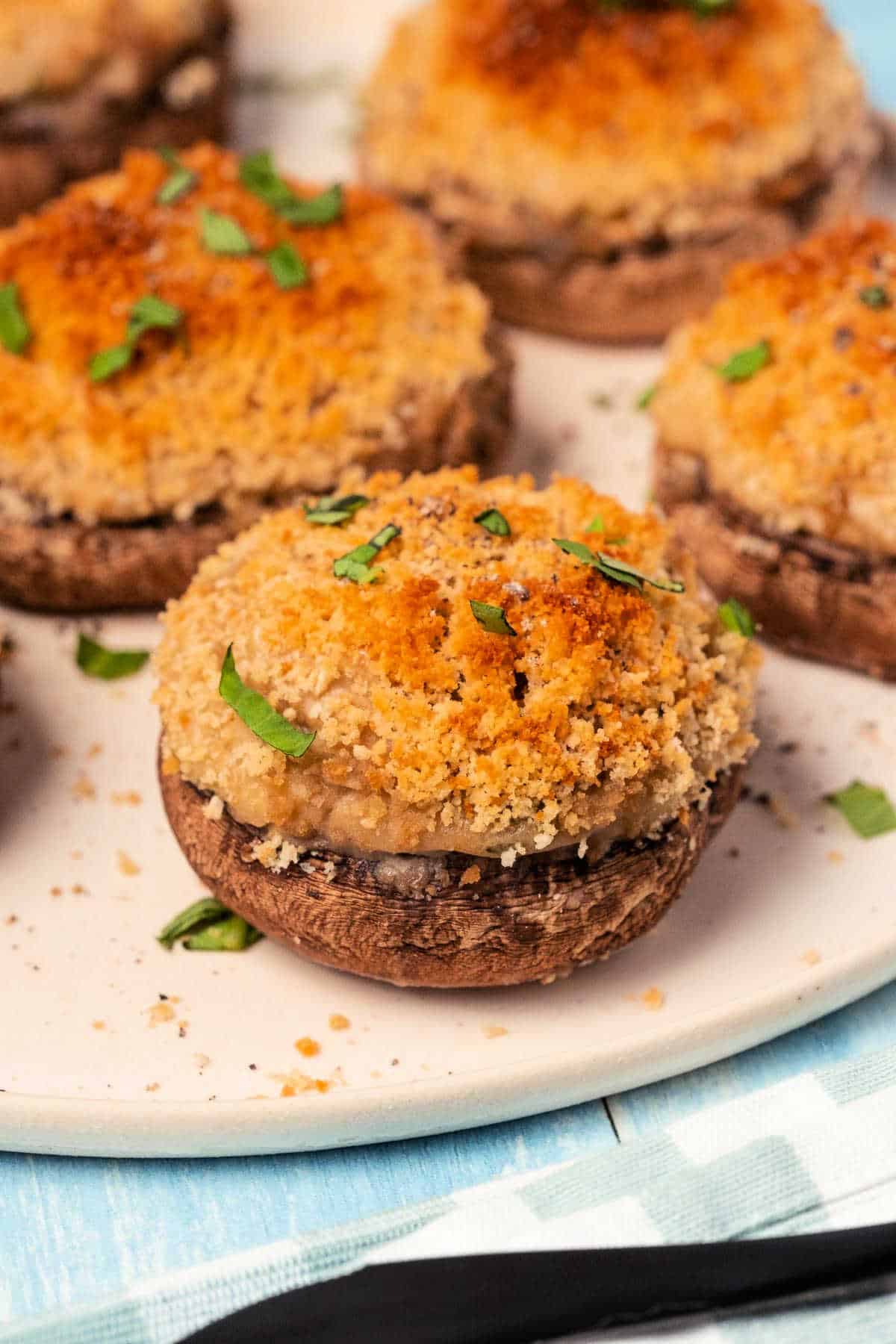 Vegan stuffed mushrooms on a white plate. 