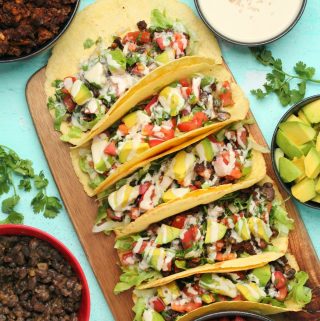 Vegan tacos on a wooden board.