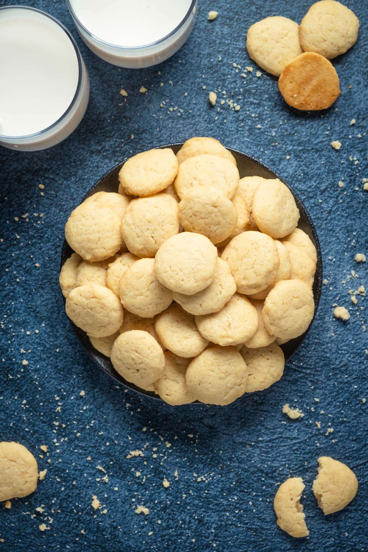 Vegan vanilla wafers stacked up on a plate. 