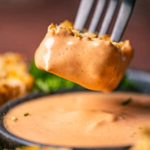 Vegan nugget dipped in yum yum sauce.